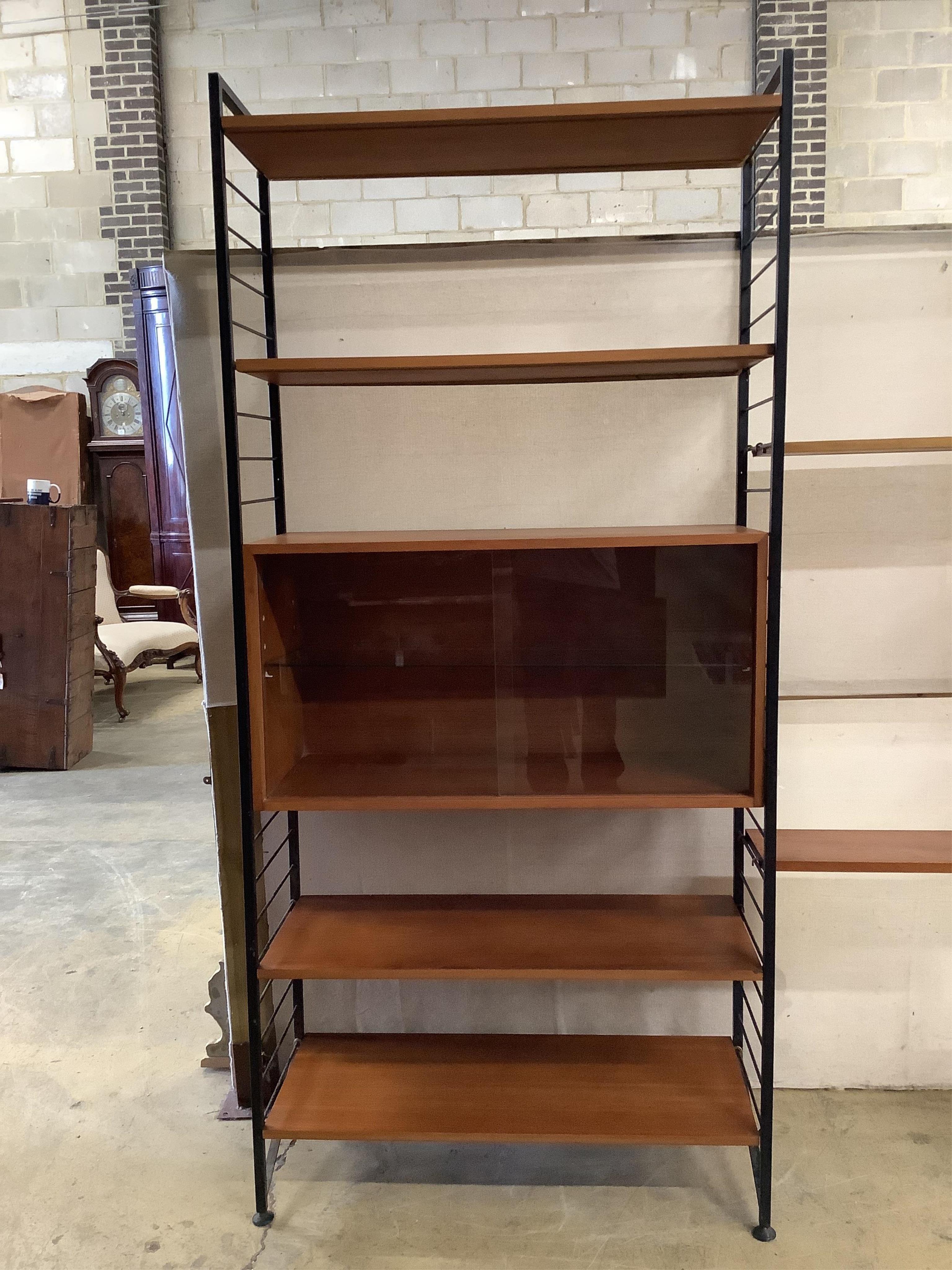 A mid century teak Ladderax shelving unit, width 215cm, depth 35cm, height 201cm. Condition - good